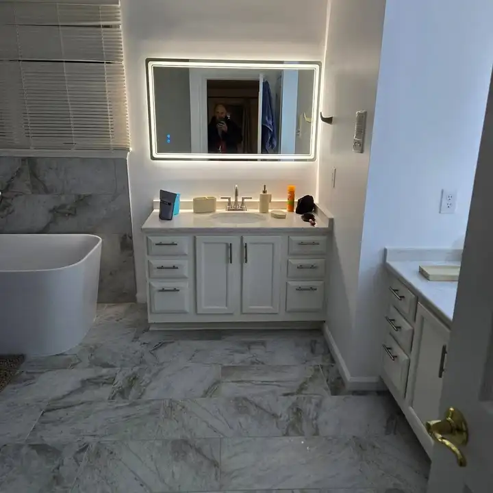 Double vanity with an LED mirror on a marble-look floor