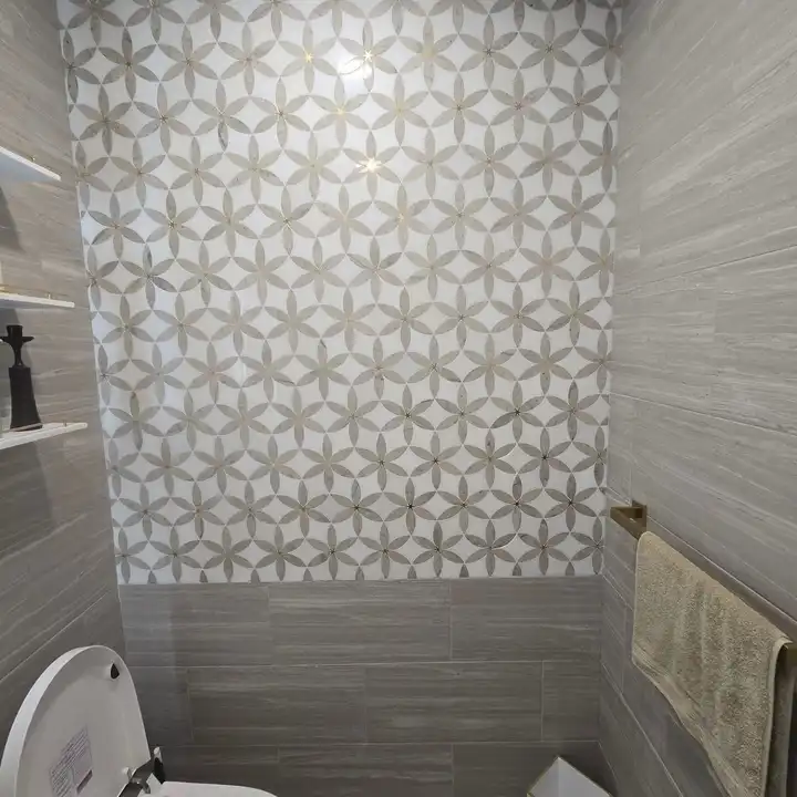 Close view of the patterned porcelain meeting the wood-look plank wall