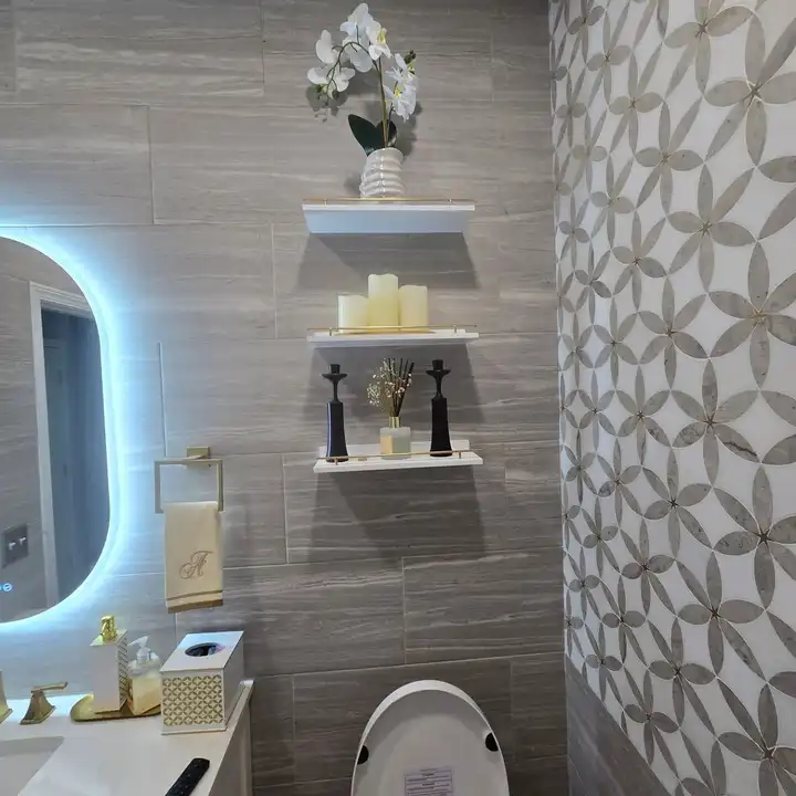 Floating shelves set into the patterned feature wall, gold brackets