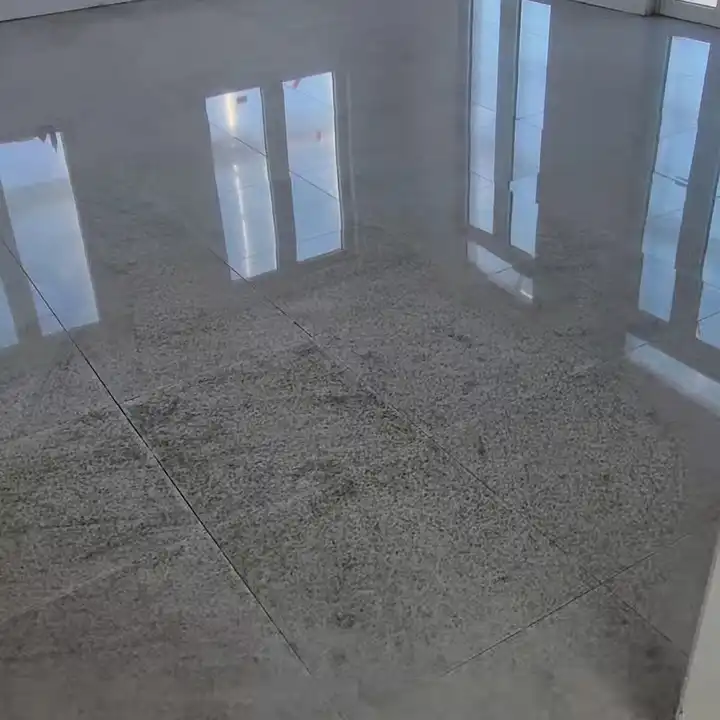 Polished large-format floor reflecting the windows of an empty room