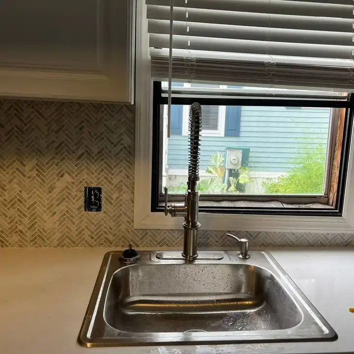 Mosaic backsplash returned to the window trim above the kitchen sink