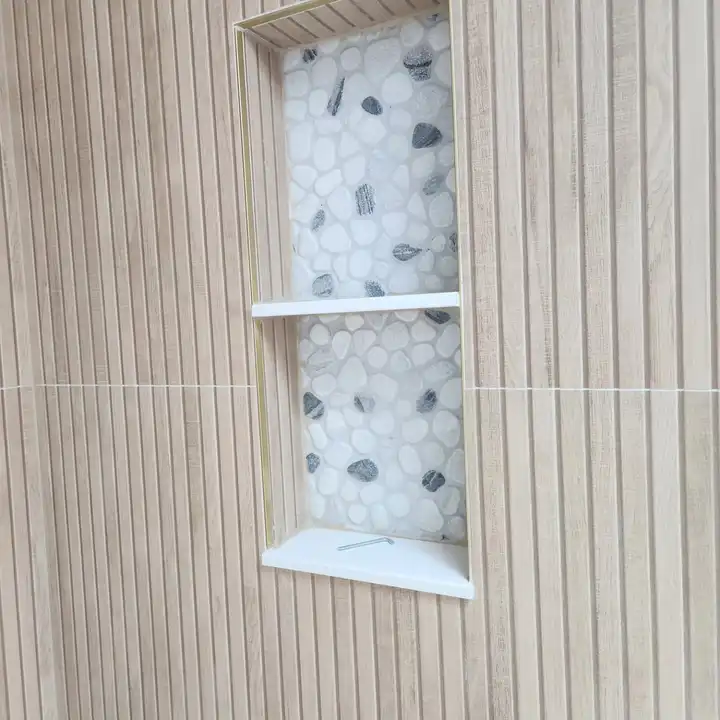 Two-shelf recessed niche with a pebble mosaic back in a wood-look wall