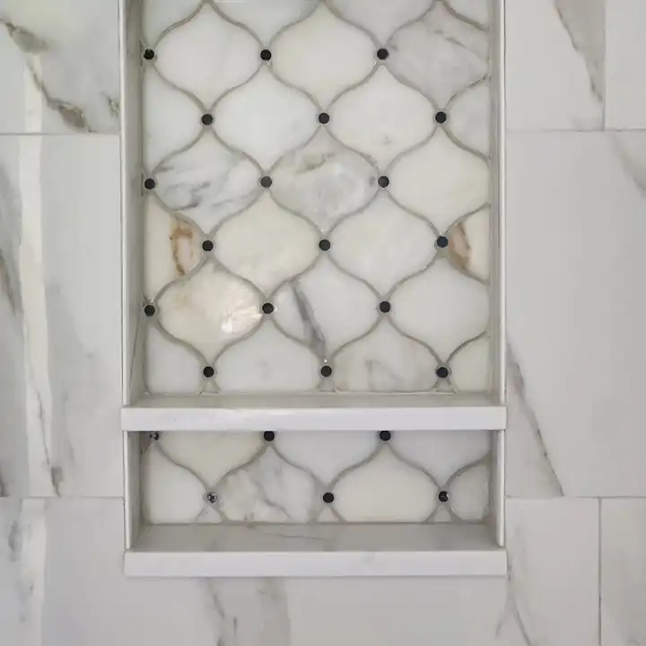 Arabesque marble mosaic set into a recessed niche with a pencil edge